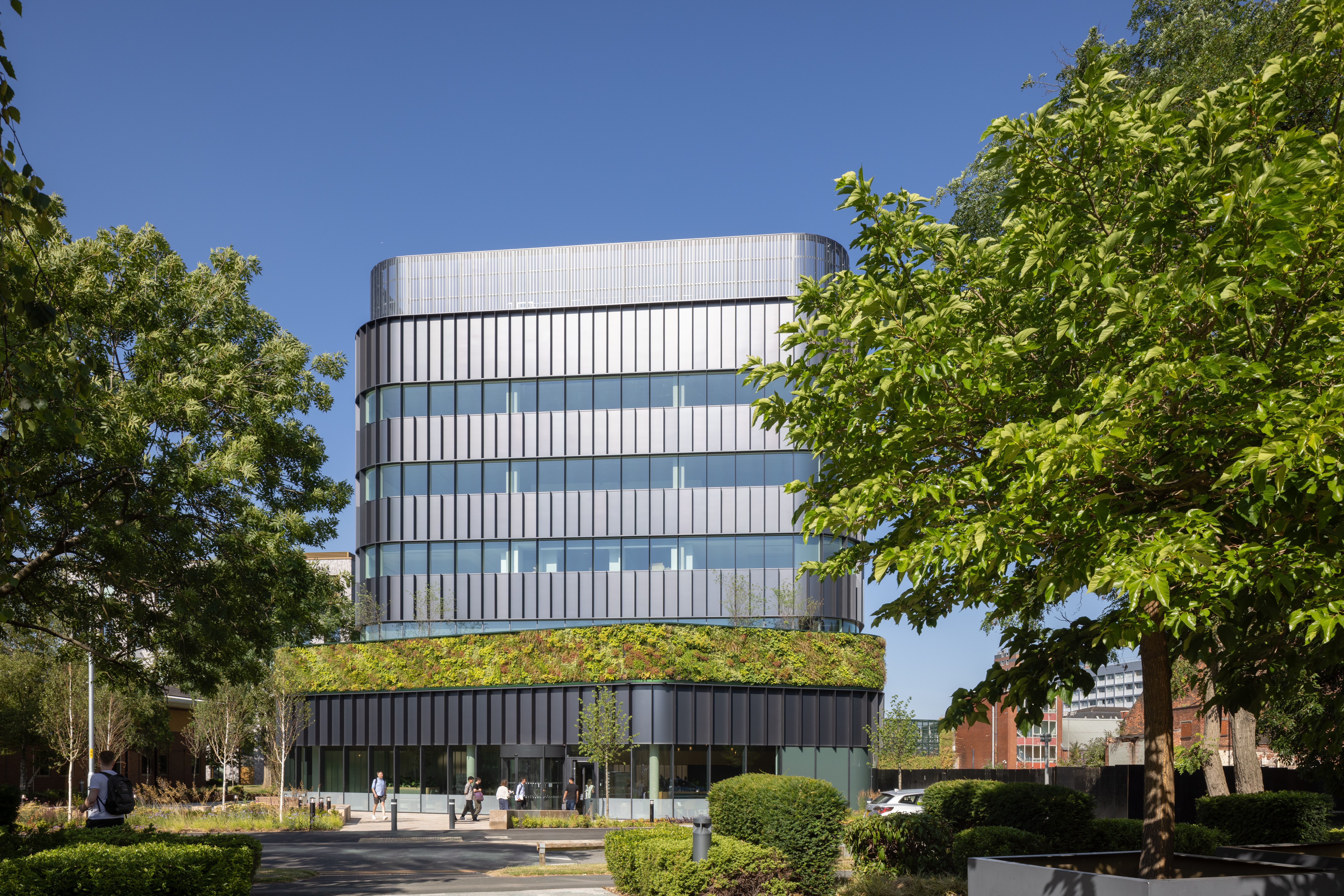 A modern laboratory and research building with a planted living wall on its facade