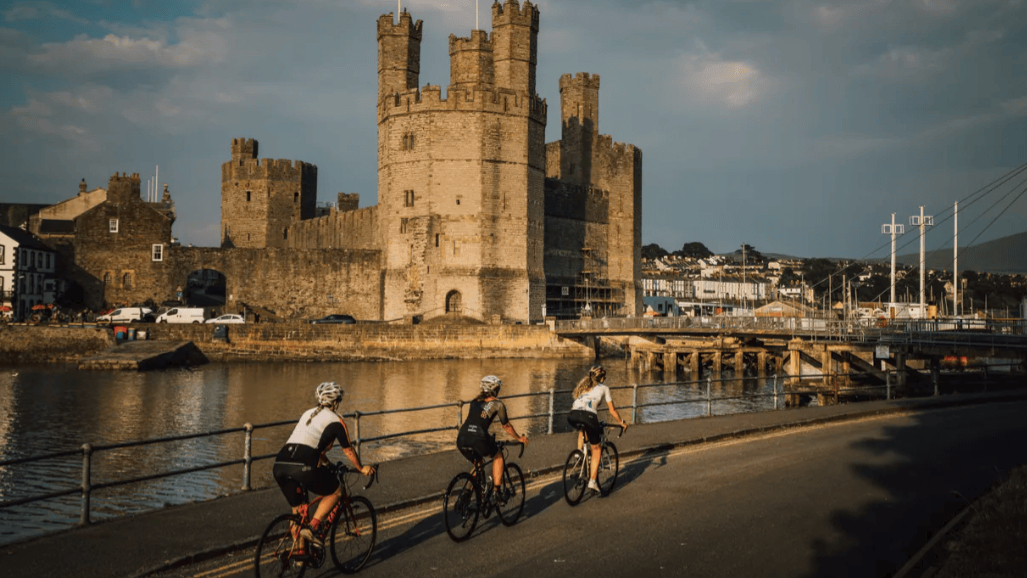 Cyclists at a bike parking and repair station on a Welsh trail